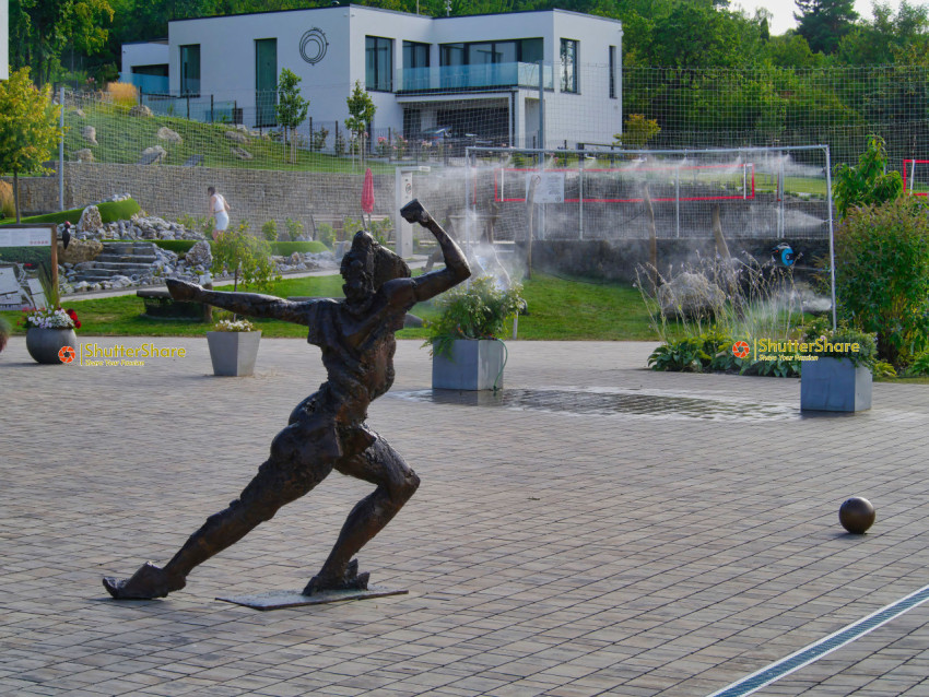 Dynamic Bronze Sculpture in Modern Garden